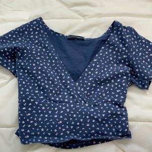 navy blue shirt with white flowers.